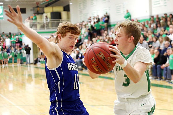 Thomas Verslues of Blair Oaks looks to pass around Hermann's Matthew Heidger during Thursday night's Class 3 District 9 semifinal game at Wardsville. Verslues scored a team-high 20 points to lead Blair Oaks to a 63-52 win.
