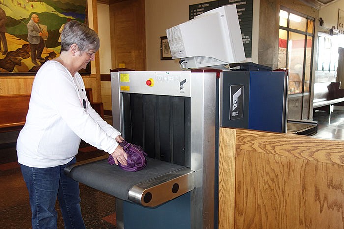 Pat Stafford feeds her handbag into the security scanner at the Callaway Courthouse. While not operational yet, it'll soon be a required stop for everyone entering the building.