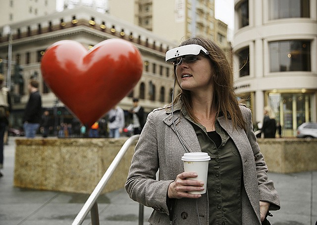 Yvonne Felix wears eSight electronic glasses and looks around Union Square during a visit Feb. 2 to San Francisco. The glasses enable the legally blind to see. Felix was diagnosed with Stargardt's disease after being hit by a car at the age of seven.