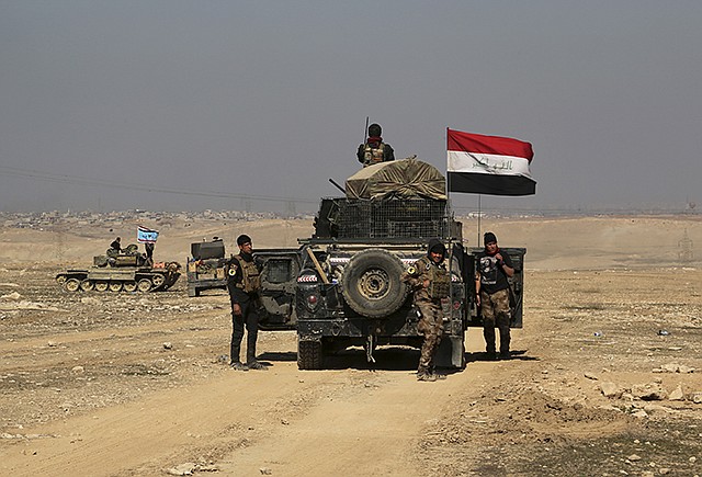 Iraqi special forces advance Thursday toward the western side of Mosul, Iraq. The advance comes as part of a major assault that started five days earlier to drive Islamic State militants from the western half of Mosul, Iraq's second-largest city.