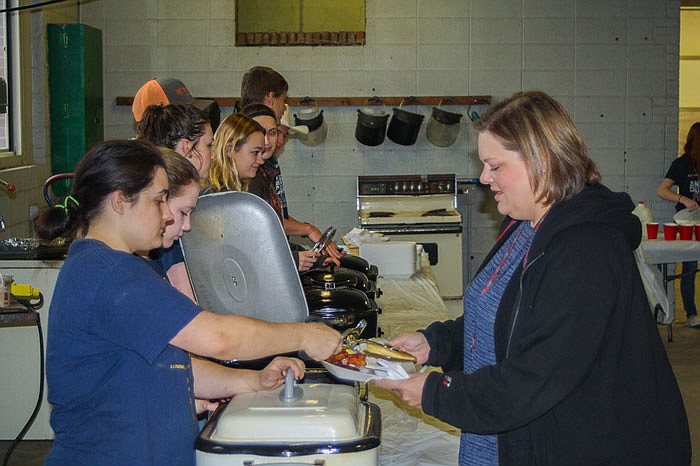 FFA member Teresa York serves teacher Cassie Lauer a pancake during Thursday morning's community breakfast. Every year, to celebrate FFA Week, FFA chapters around the nation give back to their community by hosting a free breakfast.