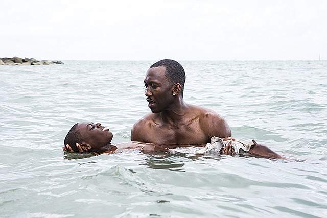 Alex Hibbert, foreground, and Mahershala Ali are shown in a scene from the film, "Moonlight."