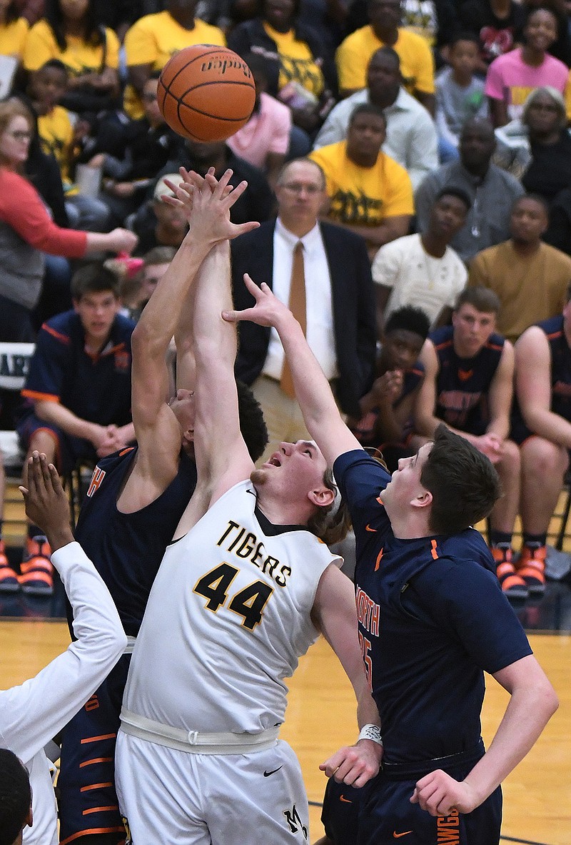 Mount Pleasant's James Moore, 44, fights for a rebound during the second quarter of their area championship game against McKinney North on Friday at Paris High School. 