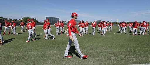 St. Louis Cardinals manager Mike Matheny watches as players stretch during a spring training baseball workout Friday, Feb. 17, 2017, in Jupiter, Fla. 
