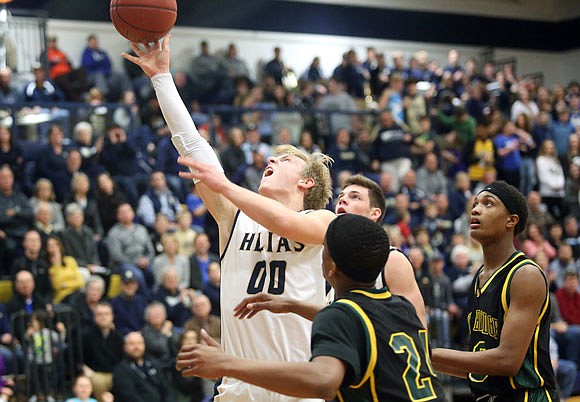 Nathan Bax of Helias goes up for a shot among a trio of Rock Bridge defenders during Friday night's game at Rackers Fieldhouse.