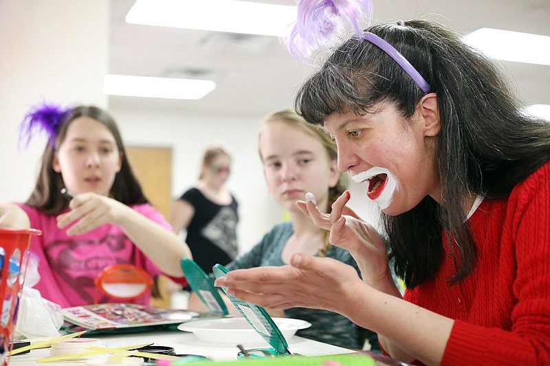 Marie Shafer demonstrates how to apply clown makeup Saturday, Feb. 25, 2017 at the second annual Clowning Workshop in the Cole County Extension Center. Students in 4-H learned clowning makeup and skill sets during the workshop.