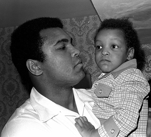 In this April 15, 1975 file photo, Heavyweight boxing champion Muhammad Ali, and Little Muhammad Ali, his 2 1/2 year old son, arrive at Miami Beach, Fla. 