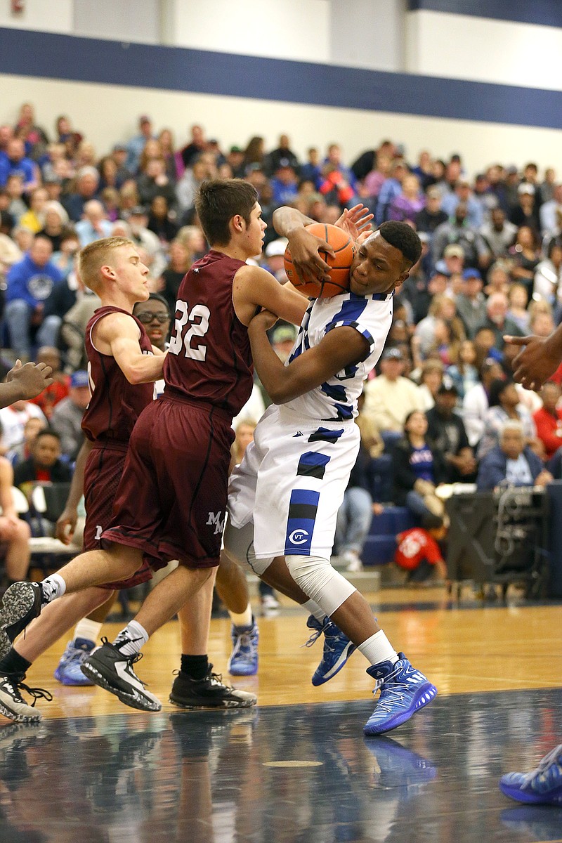 Deonte Tavie wrestles for the ball during Clarksville's basketball game on Saturday night.