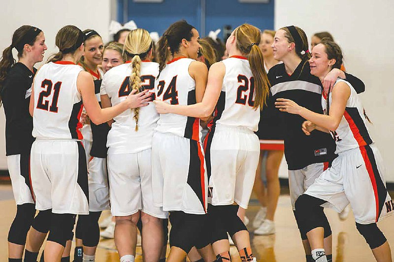 The New Bloomfield Lady Wildcats celebrate after capturing the District 8 championship Friday night, Feb. 24, 2017 with a 62-59 triumph over Eugene at Sturgeon High School. 