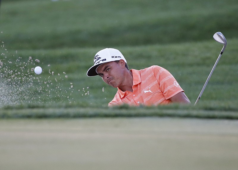 Rickie Fowler hits out of a bunker on the 18th hole the Honda Classic golf tournament, Sunday, Feb. 26, 2017, in Palm Beach Gardens, Fla. Fowler won the tournament. 