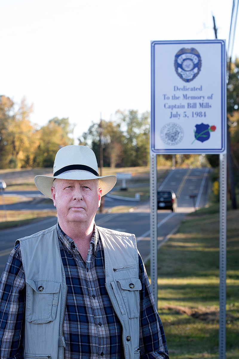 Jim Smith, former De Queen, Ark., police chief, is photographed in front of one of the four signs the city recently erected honoring the four city officers who died in an auto accident July 5, 1984. 