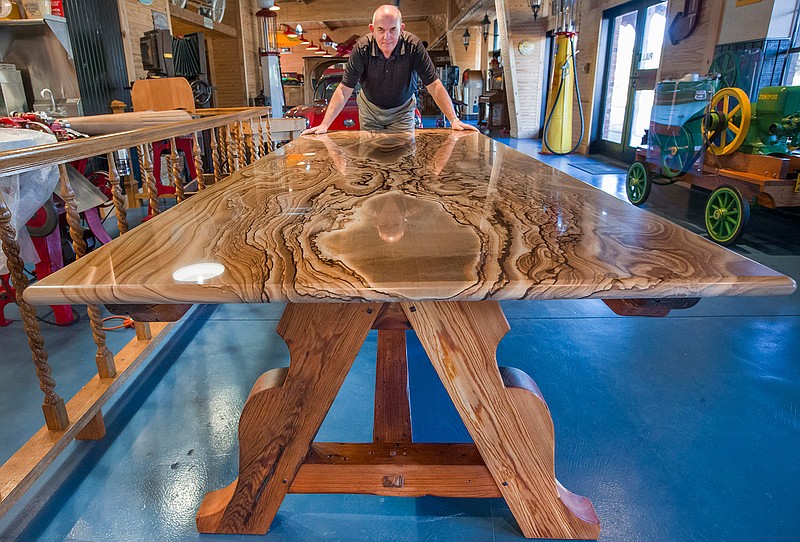 Wood worker Walter Hansen displays a table that he created using wood from the now demolished Fort Crockett site on Feb. 16, 2016 in League City, Texas.  