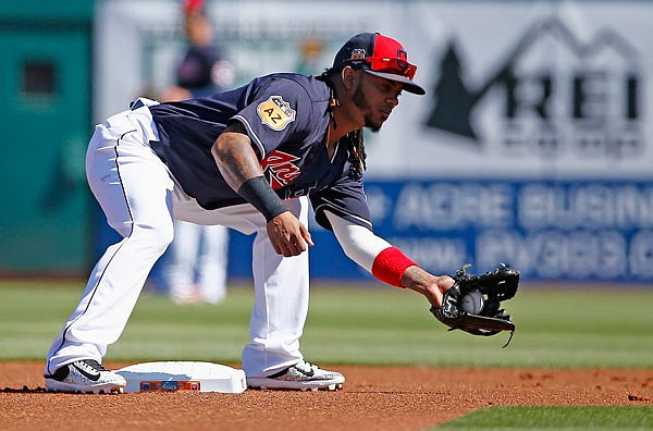 Indians second baseman Michael Martinez catches a throw down to second base during the first inning of a spring training game Saturday against the Reds in Goodyear, Ariz.
