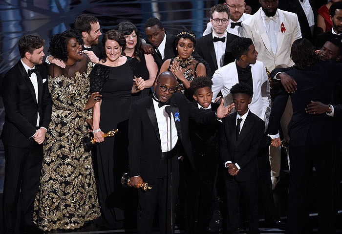 Barry Jenkins, foreground center, and the cast accept the award for best picture for "Moonlight" at the Oscars on Sunday.
