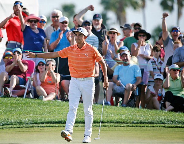 Fans cheer for Rickie Fowler after his putt on the 12th hole Sunday during the final round of the Honda Classic in Palm Beach Gardens, Fla.