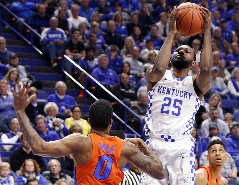 Kentucky's Dominique Hawkins is defended by Florida's Kasey Hill on Saturday during the first half in Lexington, Ky. 
