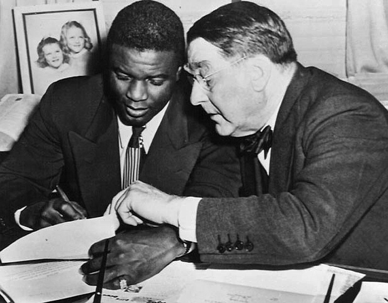 In this undated photo, Jackie Robinson, left, and Branch Rickey look 