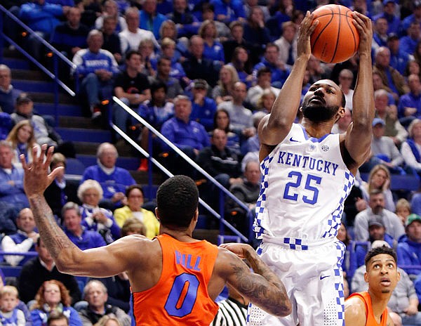 Kentucky's Dominique Hawkins shoots while defended by Florida's Kasey Hill during the first half of Saturday's game in Lexington, Ky.