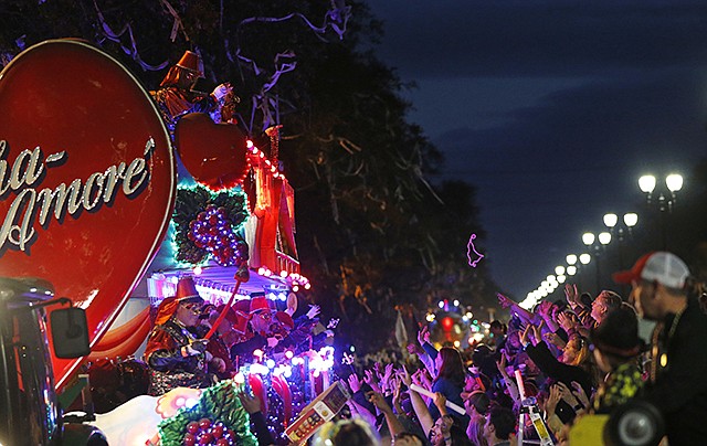 Float riders toss beads Sunday during the Krewe of Bacchus Mardi Gras parade in New Orleans.