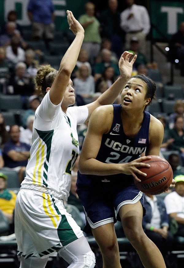 Connecticut forward Napheesa Collier goes to the basket while being guarded by South Florida forward Tamara Henshaw during the second half of Monday night's game in Tampa, Fla.