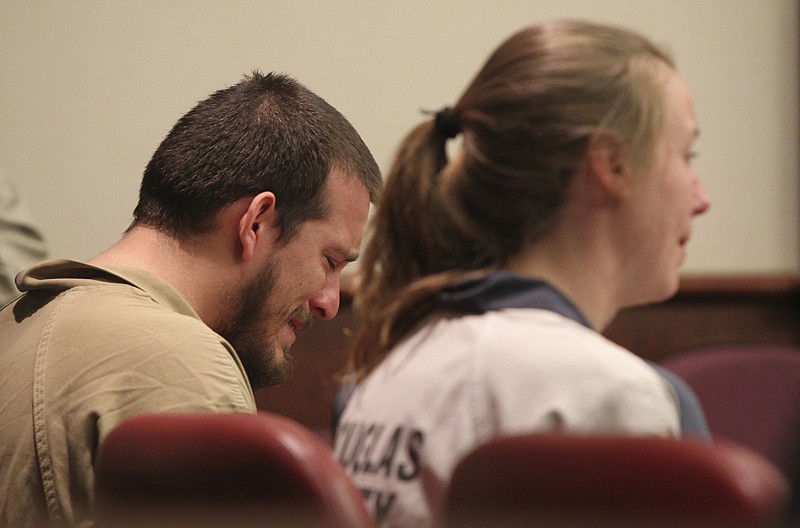 Jose Torres, weeps in his seat during his sentencing Monday at the Douglas County Courthouse in Douglasville, Ga. Superior Court Judge William McClain sentenced Torres and Kayla Rae Norton, right, to lengthy prison terms Monday for their role in the disruption of a black child's birthday party with Confederate flags, racial slurs and armed threats. 
