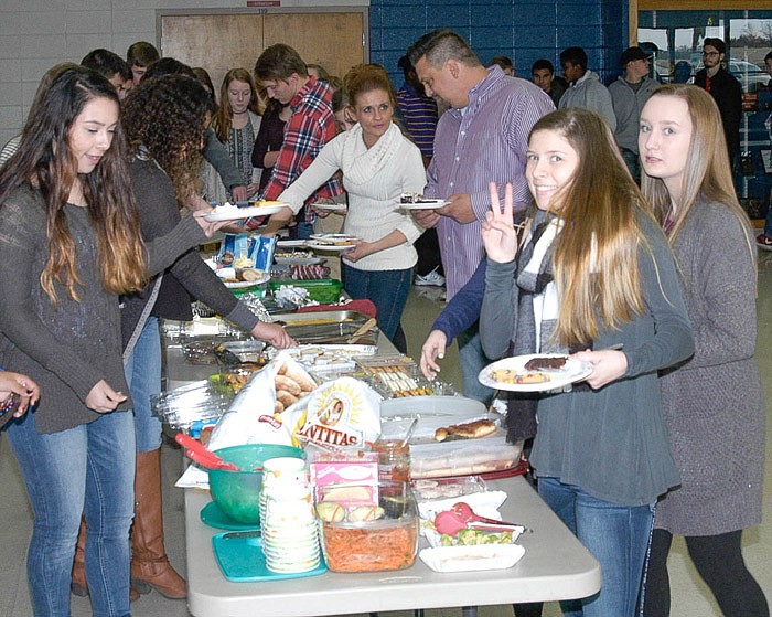 At the California High School Spanish Club "Spanish Spectacular" on Feb. 26, 2017 from left, students Ashley Leyva, Karly Wolfe and Marni Smith choose desserts and some other country-specific foods to sample.