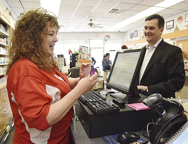 Cindy Renn waits on Jim Gwinner to demonstrate how the National Precursor Log Exchange program works Tuesday at Whaley's East End Pharmacy. Gwinner is a spokesperson for the Consumer Healthcare Products Association and demonstrated by making a purchase of pseudoephedrine without it being stopped at the cash register.