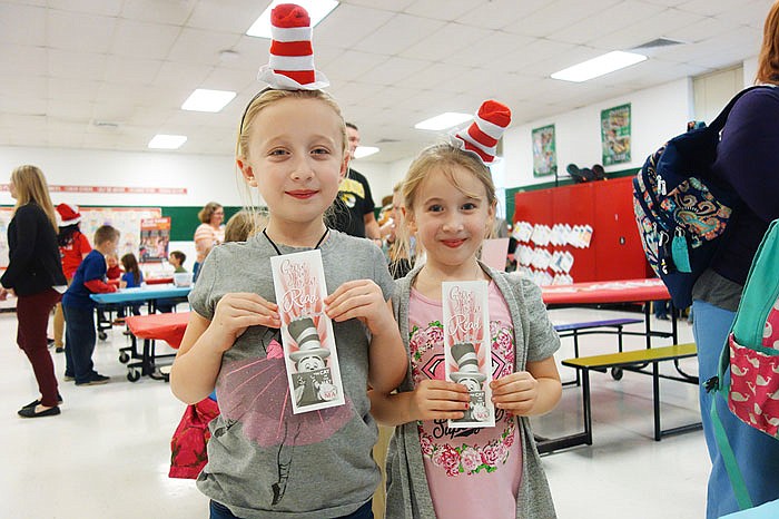 Sisters Miah and Ashlyn Strode brought their own striped hats — tiny versions of the Cat in the Hat's signature chapeau — to Auxvasse Elementary's Dr. Seuss-themed event.
