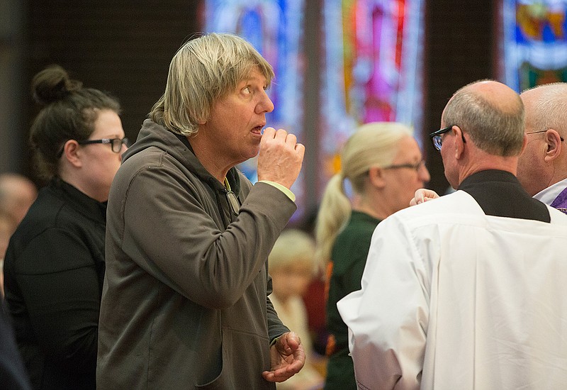 Jeff Kasal and others partake in communion during the early Ash Wednesday service at Sacred Heart Catholic Church in Texarkana, Texas. Ash Wednesday signifies the beginning of Lent, a six-week religious observance that ends the week before Easter. 