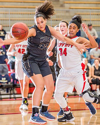 Ileah Chambly of Jefferson City and Anna Harris of Holt both eye a missed free throw during Thursday night's game at Fleming Fieldhouse.