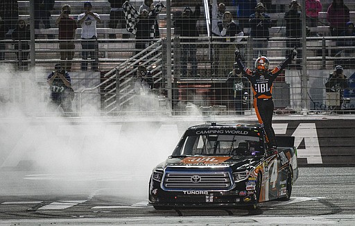 Driver Christopher Bell celebrates near the finish line after winning a NASCAR Truck series auto race at Atlanta Motor Speedway in Hampton, Ga., Saturday, March 4, 2017. 