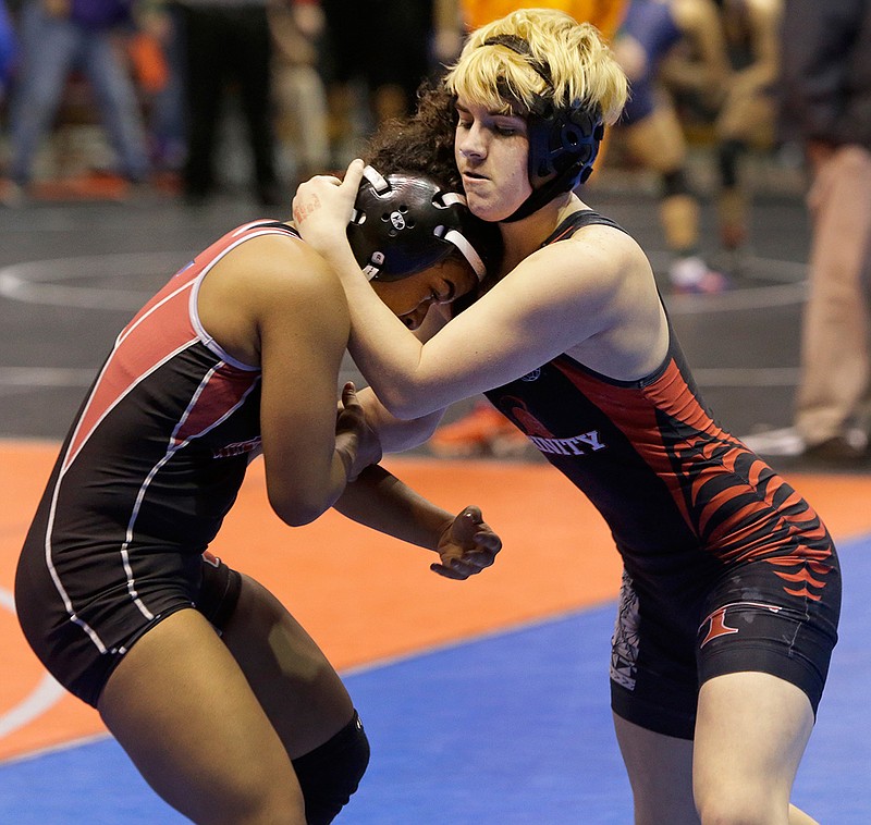 In this Friday, Feb. 24, 2017, file photo, Mack Beggs, right, a transgender wrestler from Euless Trinity, competes in a quarterfinal against Mya Engert of Amarillo Tascosa during the state wrestling tournament in Cypress, Texas. Beggs, who won a girls wrestling state title in Texas, says he would compete against boys if allowed and is taking lower doses of testosterone to try to be fair to his opponents.