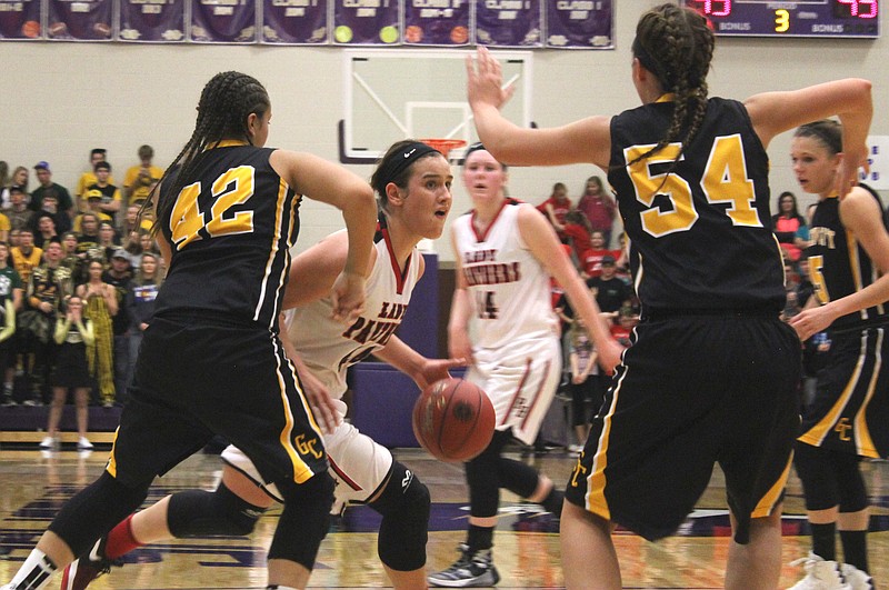 Prairie Home's Shianne Rhorer looks to drive through a pair of Green City defenders in Saturday's Class 1 quarterfinal game.