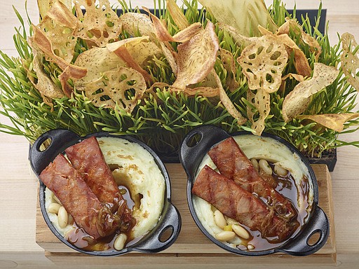 This March 3, 2017 photo provided by The Culinary Institute of America shows bangers and mash in Hyde Park, N.Y. This dish is from a recipe by the CIA. (Phil Mansfield/The Culinary Institute of America via AP)