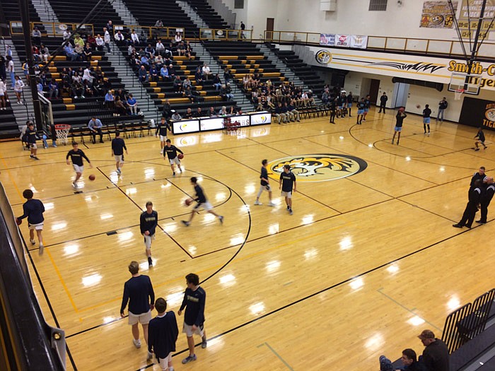 Players warm up at Sedalia Smith-Cotton High School Tuesday night, March 7, 2017, in advance of the Class 4 boys sectional game between Helias and Grandview.