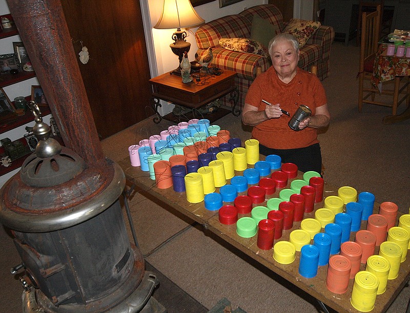These colorful tin cans are Oreta Wright's beginning decorations for a Christmas project she has for Kildare, Texas. She hopes to get everyone to make and share holiday decorations to be placed along the roadside "from west to the east city limits" through the village.
