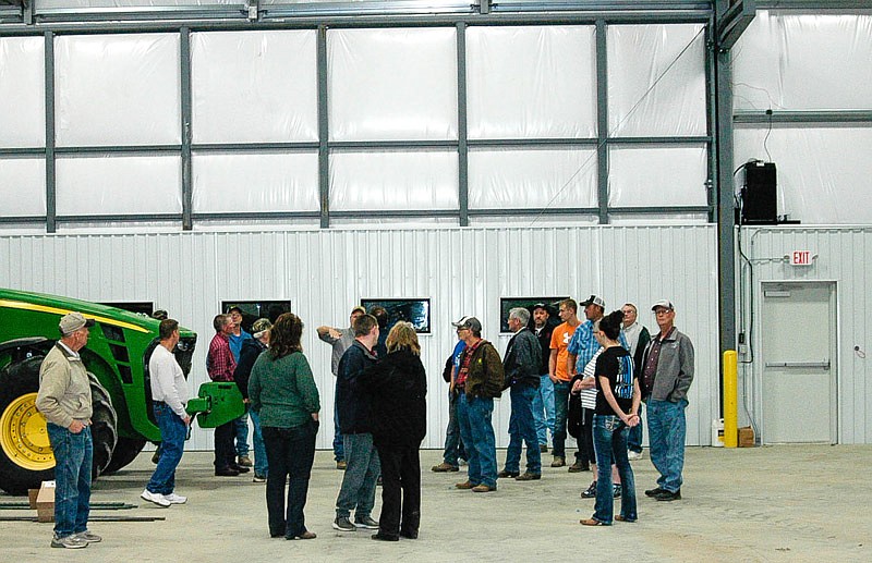 The Young Farmers group checks out the new shop area of the Sydenstricker Implements facility near Tipton. Store manager Scotty Hirst explains the 40-foot-wide door behind him. The door allows equipment to be brought inside to be worked on, including large combines without removing the headers.