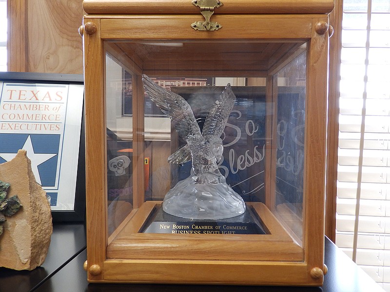 The Business Spotlight Award, a crystal eagle enclosed in a wood-and-glass case, will be presented to the winning business member of the Chamber of Commerce at the annual awards banquet Tuesday evening at First Baptist Church of New Boston, Texas. The Doyle Corley Award, the Lloyd Wilson Award and the Business Spotlight Award will be given. The theme for the event is "The Little Town with the Big Heart."
