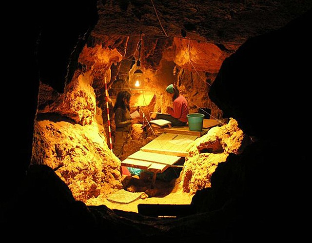 In this photo provided by Antonio Rosas, Paleoanthropology Group MNCN-CSIC, shows work in the Tunnel of Bones cave, where 12 Neanderthal specimens dating around 49,000 years ago have been recovered. Scientists got a sneak peek into the kitchen and medicine cabinets of three Neanderthals by examining the DNA of the stuff stuck on and between their teeth. What they found smashes a common meaty misconception of the caveman diet and hints that one sickly Neanderthal had found what may be primitive versions of penicillin and aspirin to help him with his pain.
