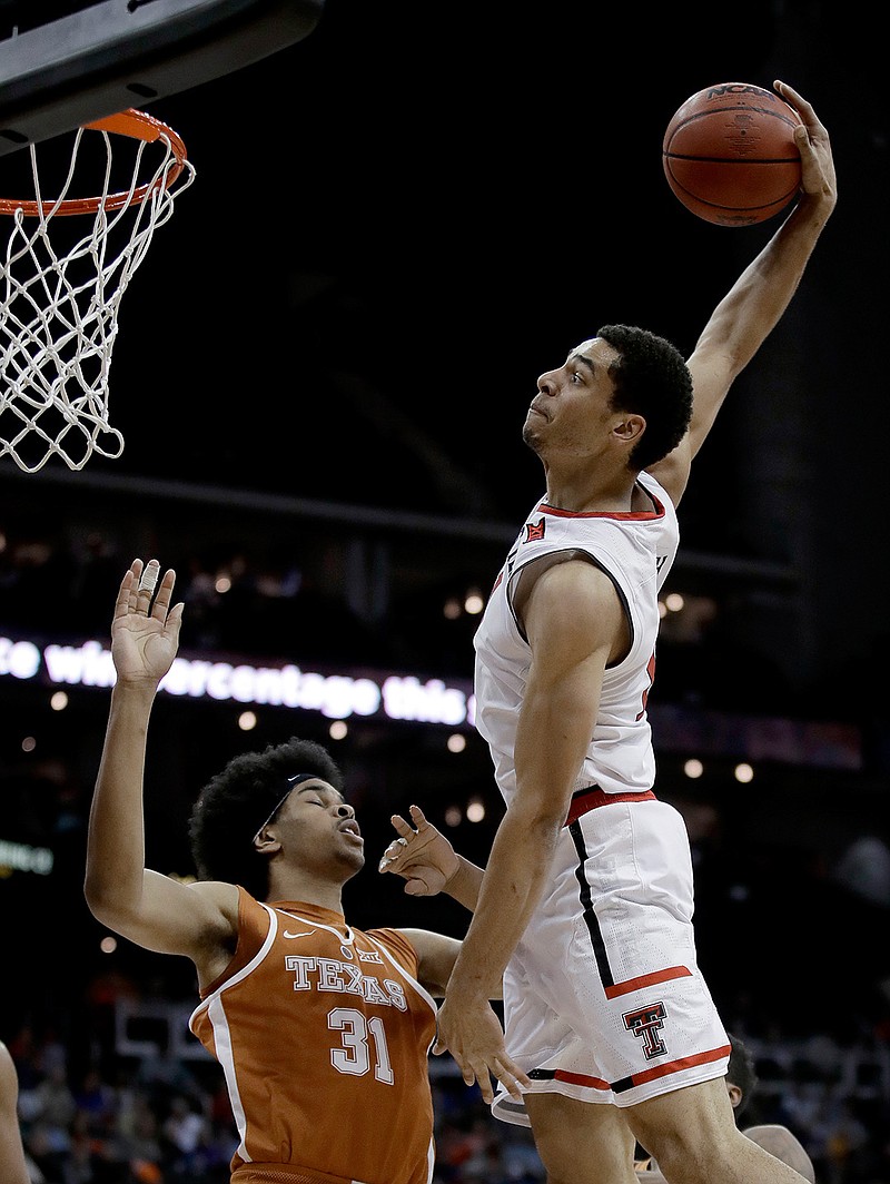 Texas Tech's Zach Smith (11) goes to the basket as Texas' Jarrett Allen (31) defends during the first half of an NCAA college basketball game in the Big 12 tournament Wednesday, March 8, 2017, in Kansas City, Mo. 