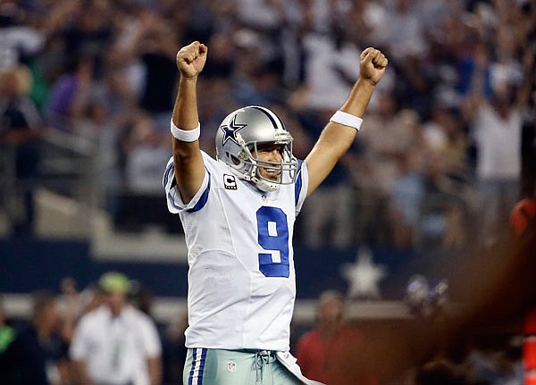 In this Sept. 28, 2014, file photo, Cowboys quarterback Tony Romo celebrates a touchdown run by DeMarco Murray during the second half of a game against the Saints in Arlington, Texas.