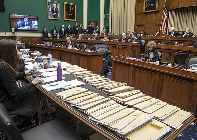 Folders containing amendments to the GOP's "Obamacare" replacement bill are spread on a conference table Thursday on Capitol Hill in Washington, as members of the House Energy and Commerce Committee worked through the night.