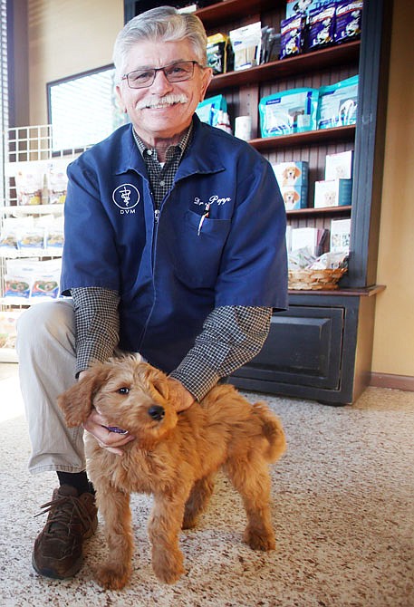 Greg Popp poses with Thatcher at his veterinary practice, Weathered Rock Veterinary Clinic in Jefferson City. Popp has been in business since 1980.