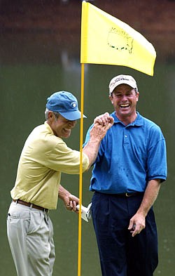 In this April 10, 2003, file photo, Jerry Pate (right) is all smiles as he is greeted by Ben Crenshaw at the ninth green after sinking the ball for par on a penalty shot from the tee box in the Masters' Par 3 Contest at the Augusta National Golf Club in Augusta, Ga.