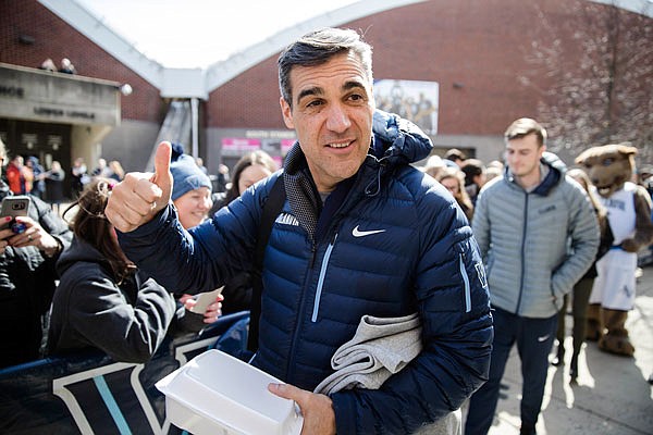 Villanova head coach Jay Wright gestures before boarding a bus as the team departs Monday for its NCAA Tournament appearance in Buffalo, N.Y.
