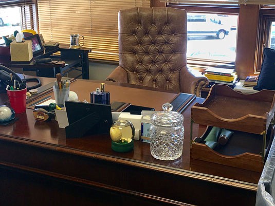 Arnold Palmer's desk is shown last week at Bay Hill Club & Lodge in Orlando, Fla. A bottle of Musk Monsieur is still on his desk, the cologne that always announced Palmer was near. Next to it are plastic cups that hold pens he used to sign thousands of autographs.