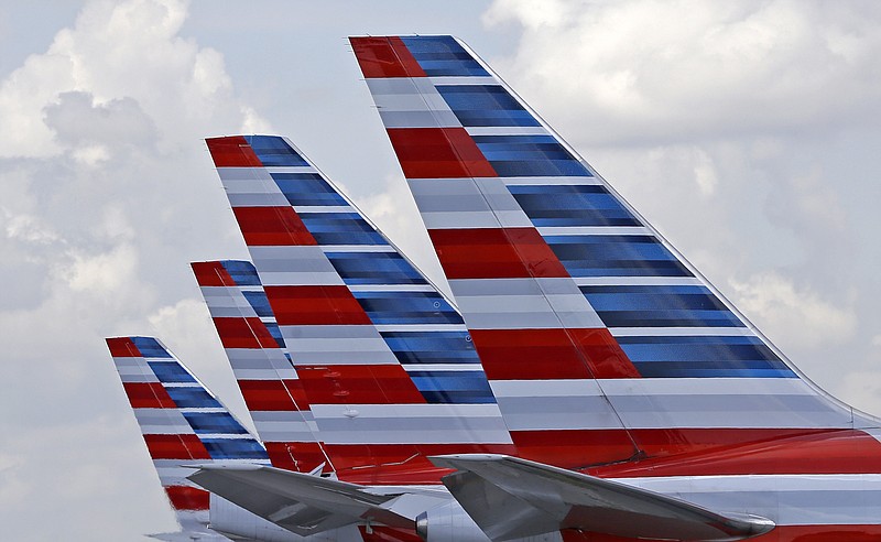 This July 17, 2015, file photo shows the tails of four American Airlines passenger planes parked at Miami International Airport in Miami. 