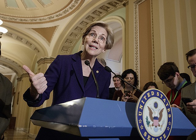 Sen. Elizabeth Warren, D-Mass., speaks Tuesday with reporters as Democrats criticize the Republican health care plan, at the Capitol in Washington. The White House and Republican leaders in Congress are scrambling to shore up support for their health care bill after findings from the Congressional Budget Office estimated 14 million people would lose insurance coverage in the first year alone under the GOP replacement for Obamacare.