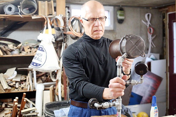 John Downs displays his hand-crafted lamps at his house in Jefferson City. Downs has been creating lamps from a variety of objects for approximately three years, but he also has an avid interest in woodcarving and crafting in general.