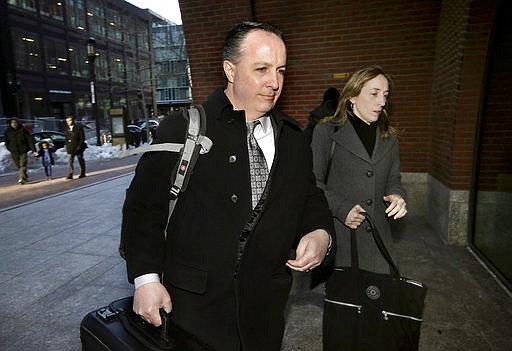 Barry Cadden, center, arrives at the federal courthouse, Thursday, March 16, 2017, in Boston, before scheduled closing arguments in his trial. Cadden, a former pharmacy executive and the president of New England Compounding Center, is charged with causing the deaths in 2012 of 25 people who received tainted steroids manufactured by the pharmacy.